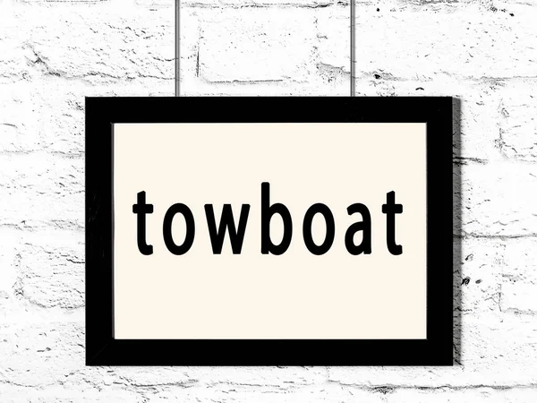 Quadro preto pendurado na parede de tijolo branco com towboat inscrição — Fotografia de Stock