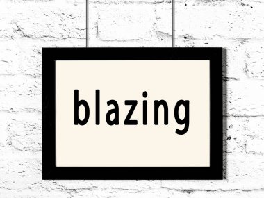 Beyaz tuğla duvarda asılı duran siyah çerçeve.