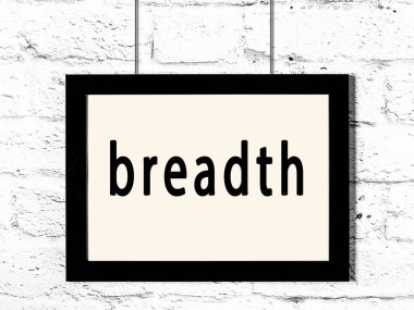 Beyaz tuğla duvarda asılı siyah çerçeve ve yazı genişliği