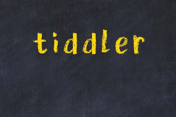 Faculdade mesa de giz com a palavra tiddler escrito em — Fotografia de Stock