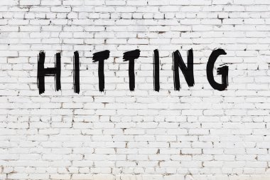 Üzerinde siyah boya yazan beyaz duvar.