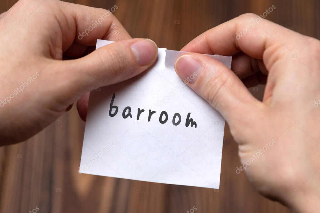 Hands tearing off paper with inscription barroom