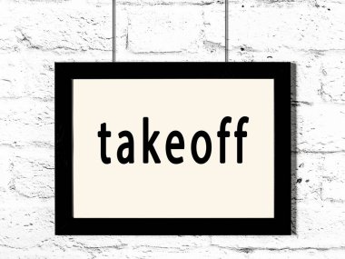 Beyaz tuğla duvarda asılı duran siyah çerçeve.