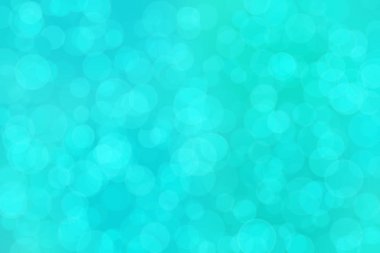 Çember şeklindeki bokeh noktalarıyla mavi ve yeşil soyut odaklanmış arkaplan