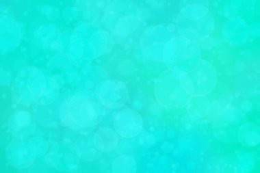 Çember şeklindeki bokeh noktalarıyla mavi ve yeşil soyut odaklanmış arkaplan