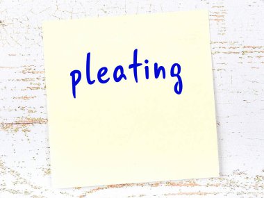 Tahta duvardaki sarı yapışkan notta elle yazılmış bir yazı var.