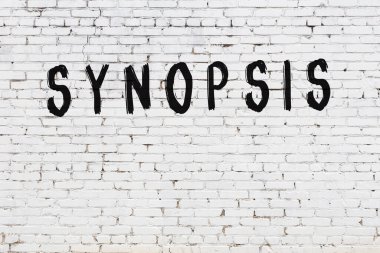 Yazı özeti beyaz tuğla duvara siyah boya ile yazılmış..