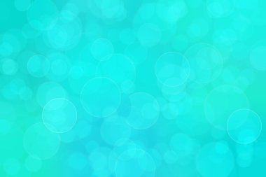 Çember şeklindeki bokeh noktalarıyla mavi ve yeşil soyut odaklanmış arkaplan