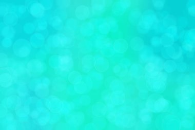 Çember şeklindeki bokeh noktalarıyla mavi ve yeşil soyut odaklanmış arkaplan