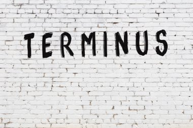 Üzerinde siyah boya bulunan beyaz tuğla bir duvar.