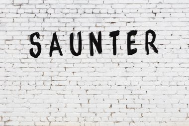 Yazılı beyaz tuğla duvar. Siyah boyalı el yazısı.