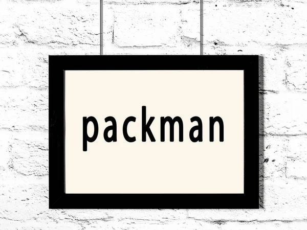 Marco Madera Negro Con Packman Inscripción Que Cuelga Pared Blanca — Foto de Stock