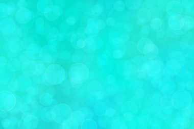 Çember şeklindeki bokeh noktalarıyla mavi ve yeşil soyut odaklanmış arkaplan