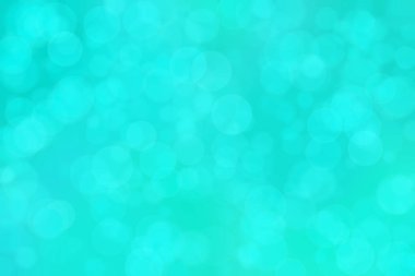 Çember şeklindeki bokeh noktalarıyla mavi ve yeşil soyut odaklanmış arkaplan