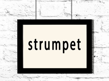 Beyaz tuğla duvara asılı siyah ahşap çerçeve. 