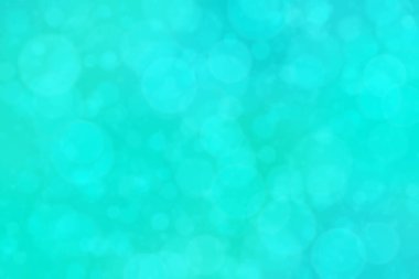 Çember şeklindeki bokeh noktalarıyla mavi ve yeşil soyut odaklanmış arkaplan