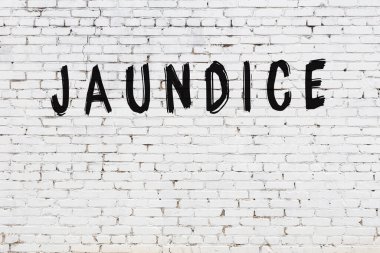 Beyaz tuğla duvara siyah boya ile yazılmış sarılık..