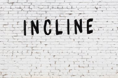 Üzerinde siyah boya olan beyaz tuğla bir duvar.