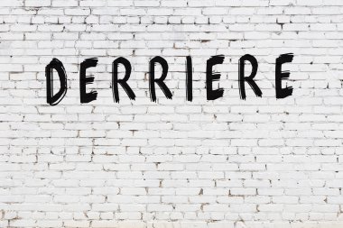 Yazılı beyaz tuğla duvar. Siyah boyalı el yazısı.