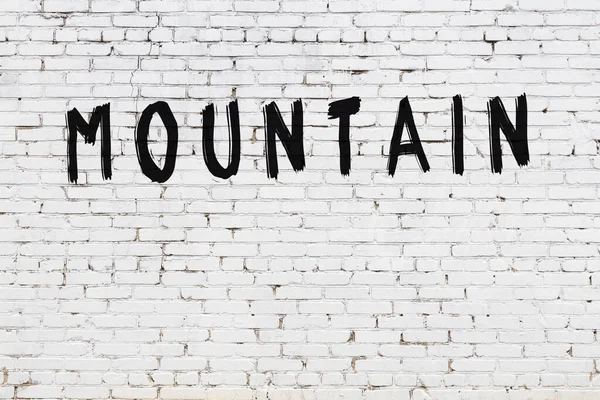 White Brick Wall Inscription Mountain Handwritten Black Paint — Stock Photo, Image