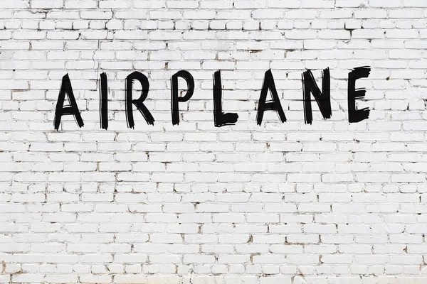 Avión Inscripción Escrito Con Pintura Negra Pared Ladrillo Blanco — Foto de Stock