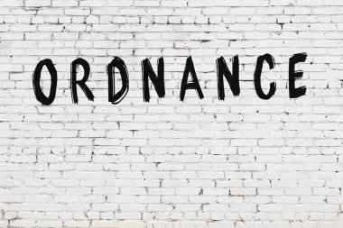 Siyah boyayla el yazısıyla yazılmış beyaz tuğlalı bir duvar.