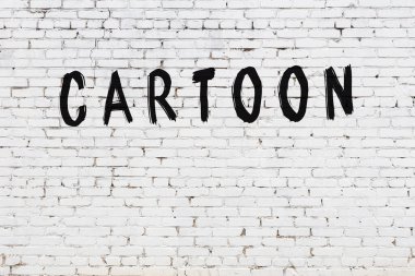 Beyaz tuğla duvara siyah boya ile yazılmış bir karikatür..