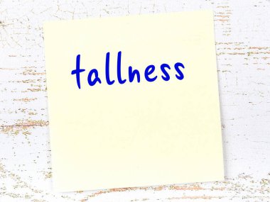 Uzunluğu hatırlatma kavramı. Tahta duvarda üzerinde yazı olan sarı yapışkan kağıt.