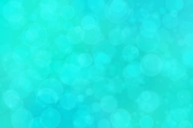 Çember şeklindeki bokeh noktalarıyla mavi ve yeşil soyut odaklanmış arkaplan