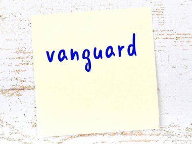 Öncü kuvvetleri hatırlatma kavramı. Tahta duvarda üzerinde yazı olan sarı yapışkan kağıt.