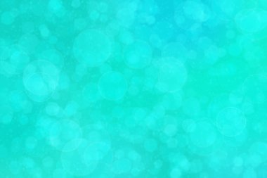 Çember şeklindeki bokeh noktalarıyla mavi ve yeşil soyut odaklanmış arkaplan