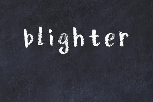 Tebeşir el yazısıyla yazılmış yazması olan adam siyah masanın üstünde.