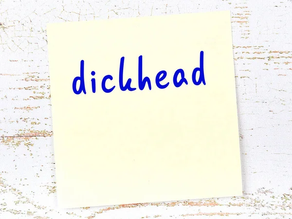 Concept Reminder Dickhead Yellow Sticky Sheet Paper Wooden Wall Inscription — Stok fotoğraf