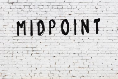 Üzerinde siyah boya bulunan beyaz tuğlalı bir duvar.