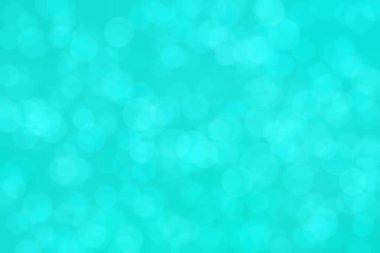 Çember şeklindeki bokeh noktalarıyla mavi ve yeşil soyut odaklanmış arkaplan