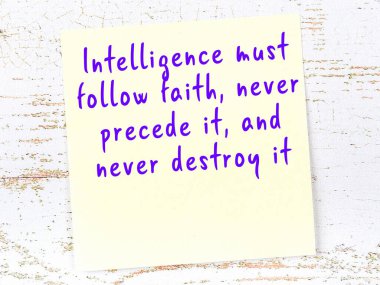 Sarı yapışkan not, ahşap duvarda el yazısıyla yazılmış zekice bir alıntıyla.