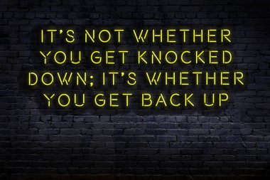 Tuğla duvardaki bilgece alıntıların neon yazıları üzerine gece görüşü