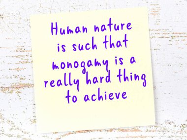 Sarı yapışkan not, ahşap duvarda el yazısıyla yazılmış zekice bir alıntıyla.