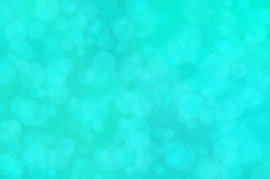 Çember şeklindeki bokeh noktalarıyla mavi ve yeşil soyut odaklanmış arkaplan