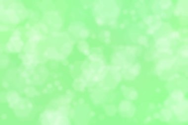 Odaklanmış arkaplanı soyutla. Yeşil üzerinde bulanık ışık lekeleri.