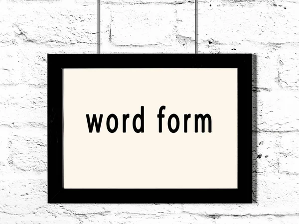 Black Wooden Frame Inscription Word Form Hanging White Brick Wall — Stock Photo, Image