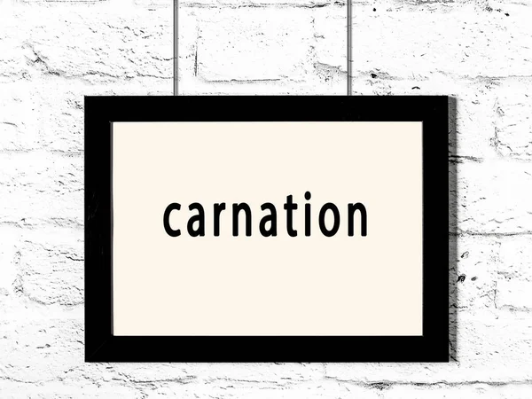 Black Wooden Frame Inscription Carnation Hanging White Brick Wall — Stock Photo, Image