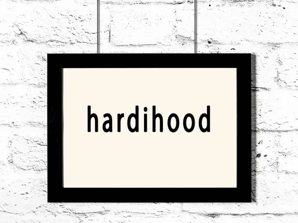 Marco Madera Negro Con Hardihood Inscripción Que Cuelga Pared Blanca —  Fotos de Stock