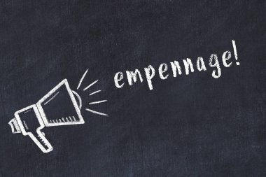 Hoparlörün tebeşir çizimi ve siyah masanın üzerine el yazısıyla yazılmış yazması.