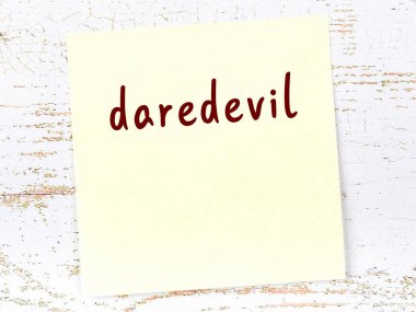 Gözüpek hakkında hatırlatma kavramı. Tahta duvarda üzerinde yazı olan sarı yapışkan kağıt.