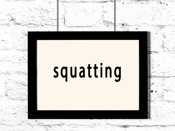 Beyaz tuğla duvara asılı siyah ahşap çerçeve. 