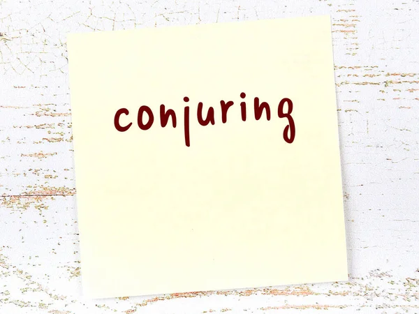 Sihirbazlık hakkında hatırlatma kavramı. Tahta duvarda üzerinde yazı olan sarı yapışkan kağıt.