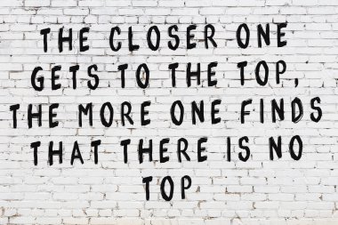 Üzerinde mantıklı alıntıların yazılı olduğu siyah boyanmış beyaz tuğla duvar.