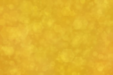 Altıgen şekilli bokeh benekleri ile odaklanmış altın soyut arkaplan