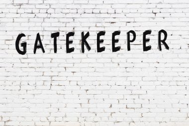 Üzerinde siyah boya bulunan beyaz tuğlalı bir duvar.